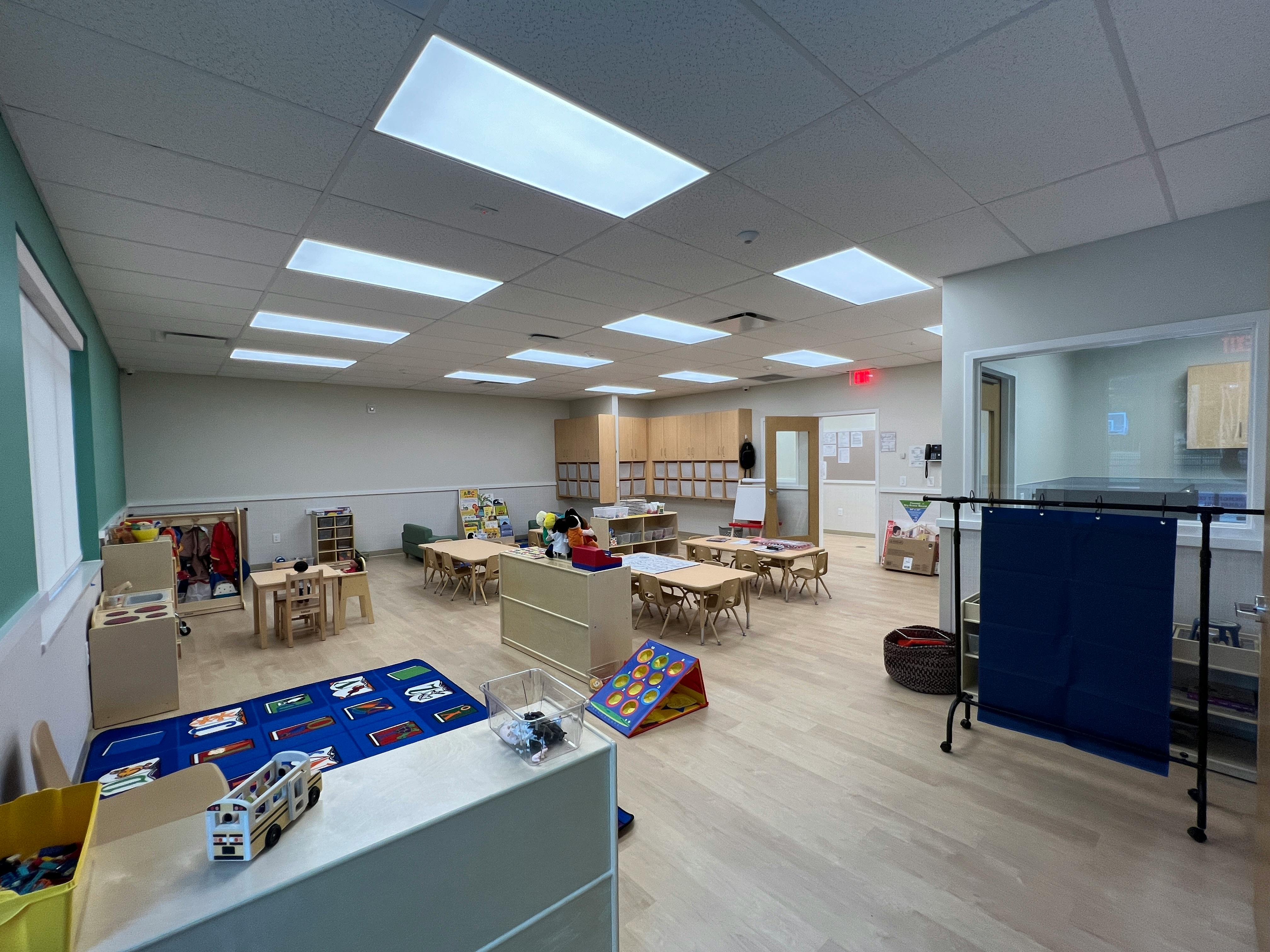 Empty classroom with small tables and chairs