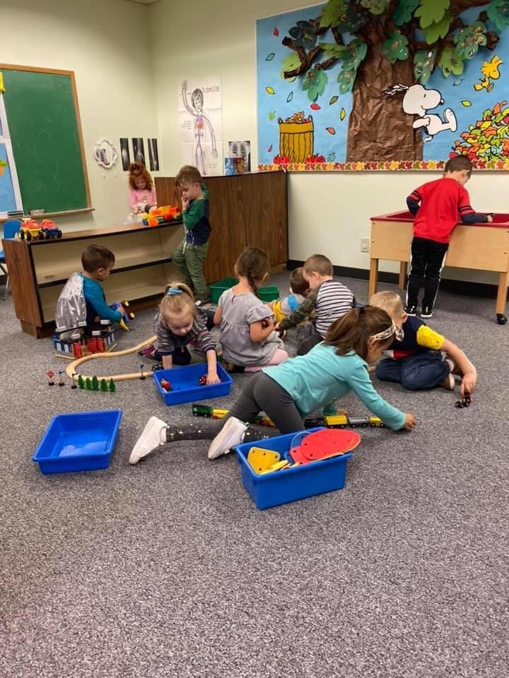 Children playing with toys in a classroom