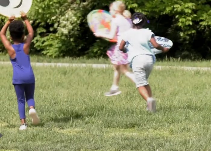 Children running in a grassy area, outdoor area