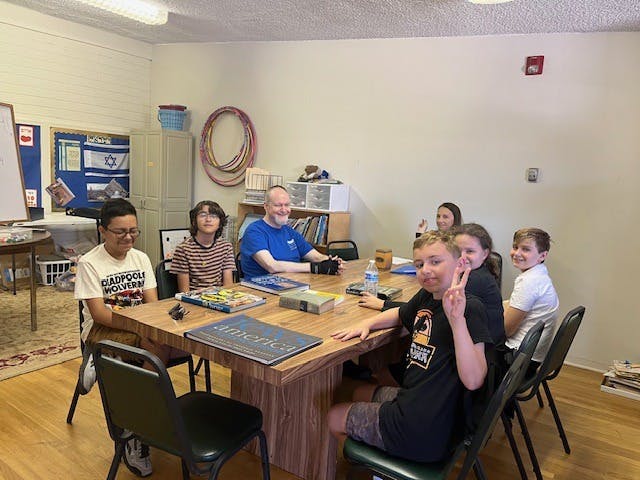 People sitting around a table with board games