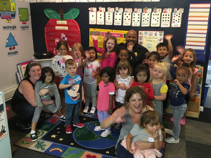 Group of adults and children in a classroom