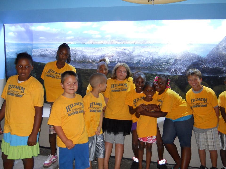 Group of children and teens in yellow shirts