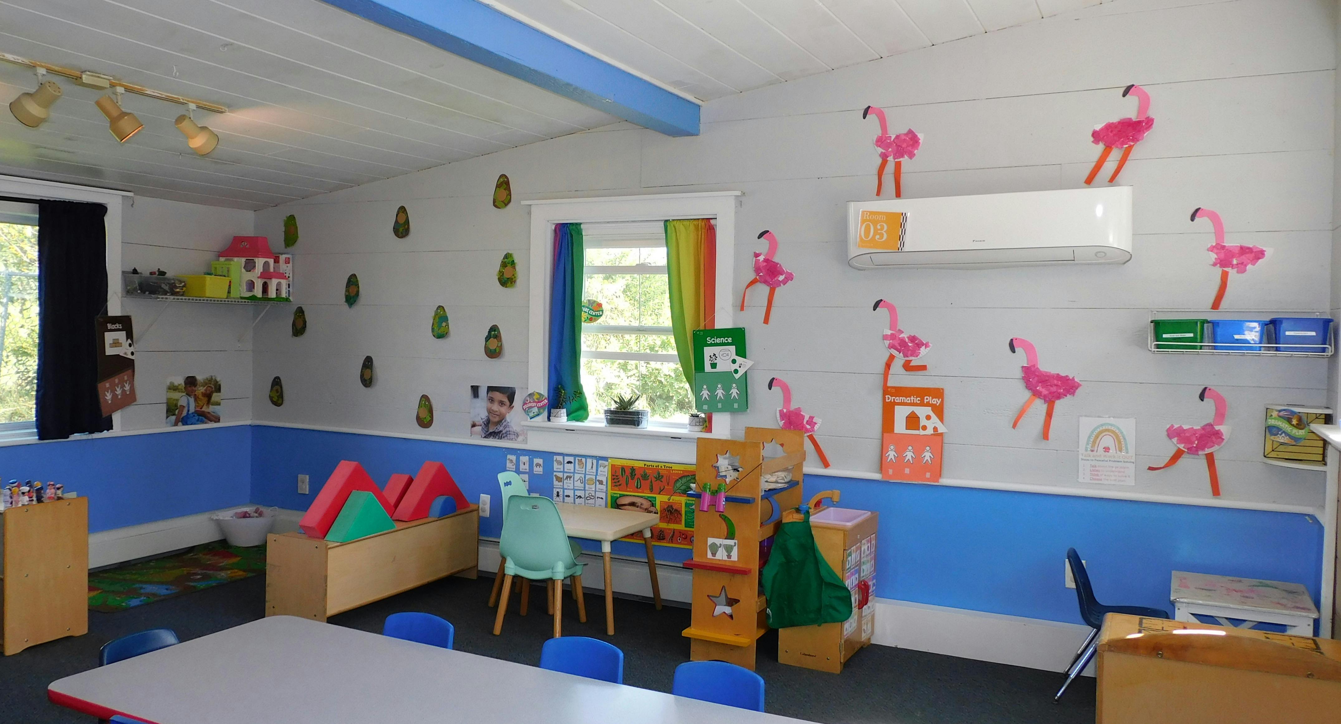 Classroom with blue walls, windows, and flamingo decorations