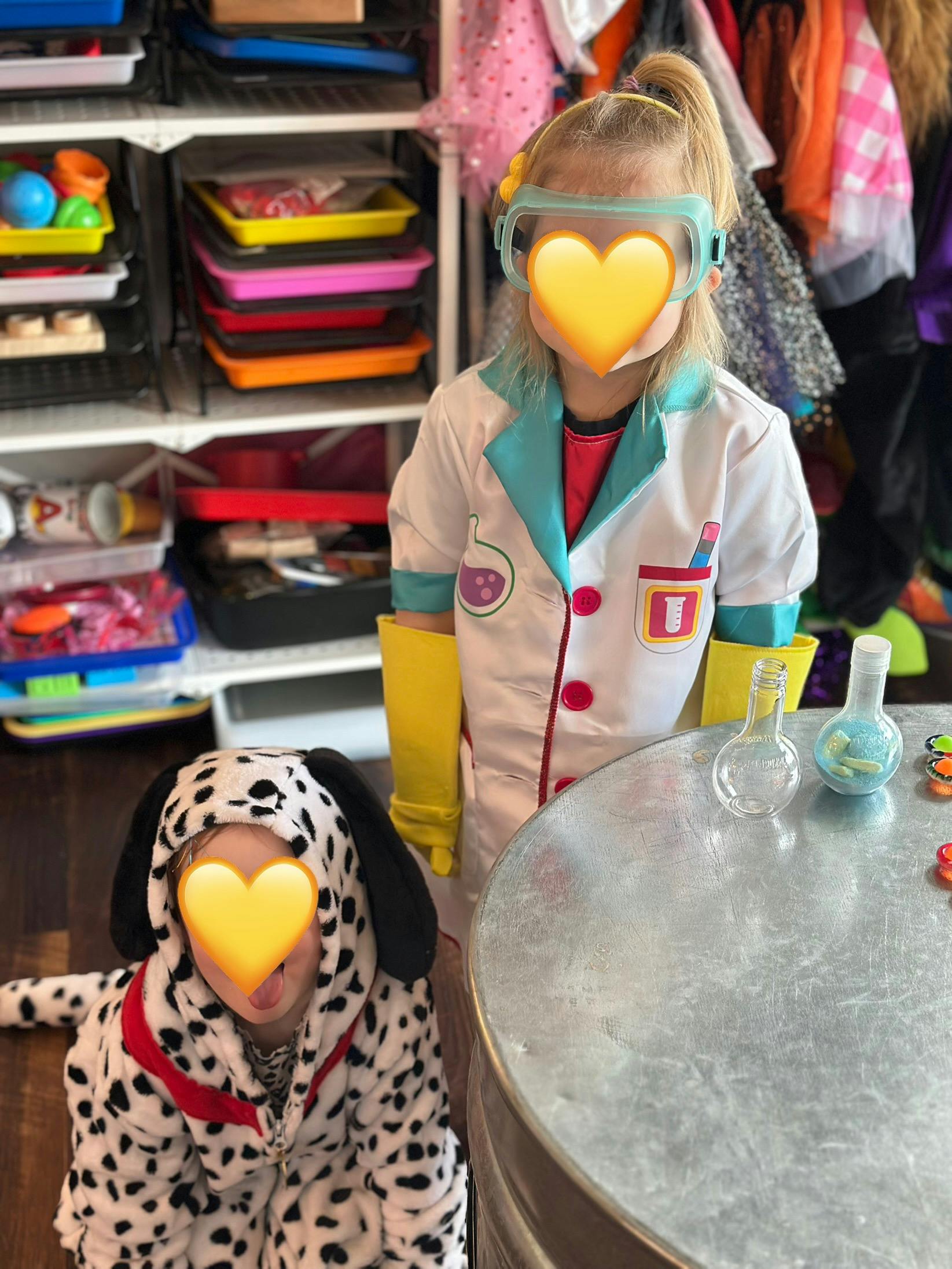 Child in scientist costume with goggles and child in dalmatian costume