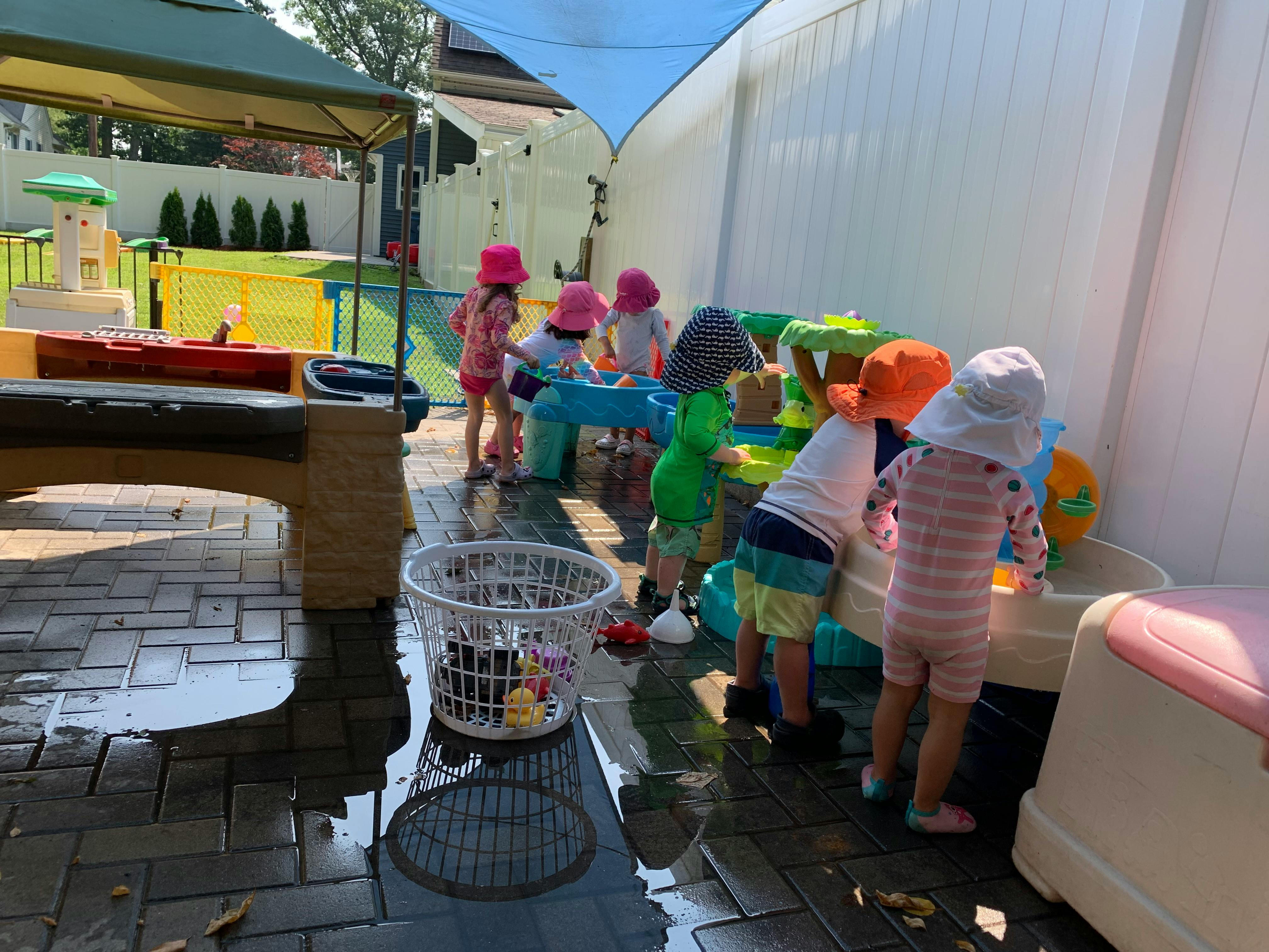 Children playing with water toys outdoors