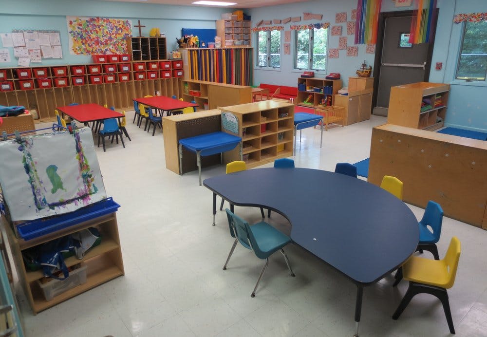 Empty classroom with small tables and chairs