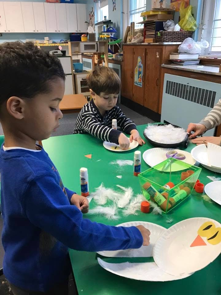 Two children doing crafts at a table