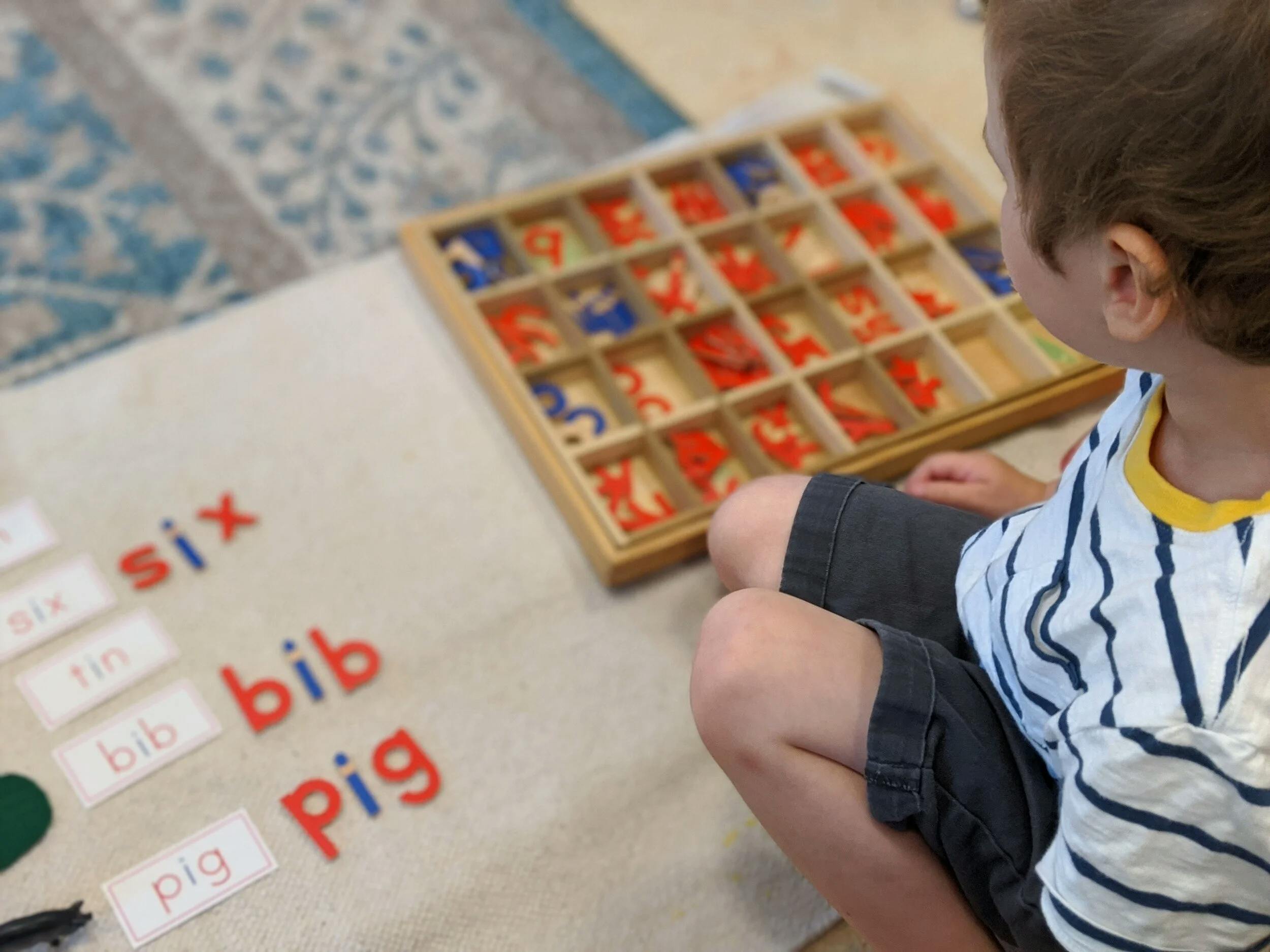 Child learning to spell words with letter tiles in a classroom