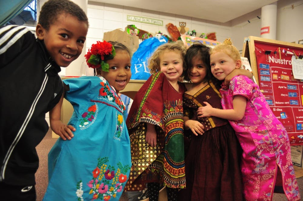 Five children in various cultural clothing