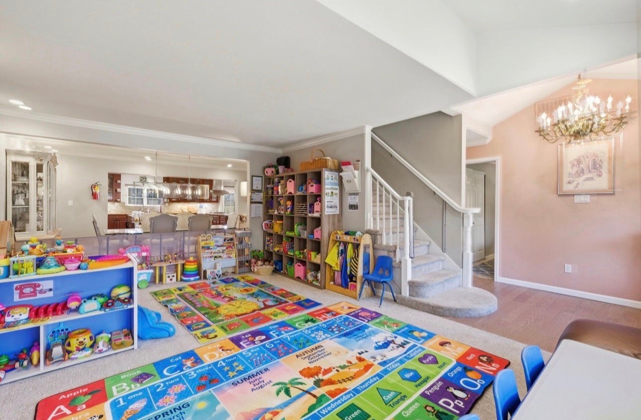 Playroom interior with educational rugs and shelves full of toys