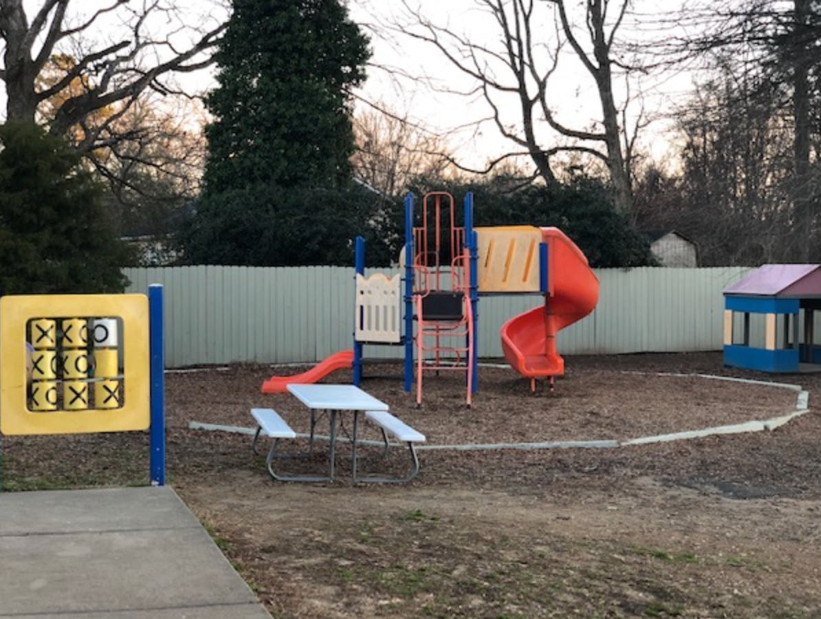 Playground with slides, climbing structure, and tic-tac-toe game
