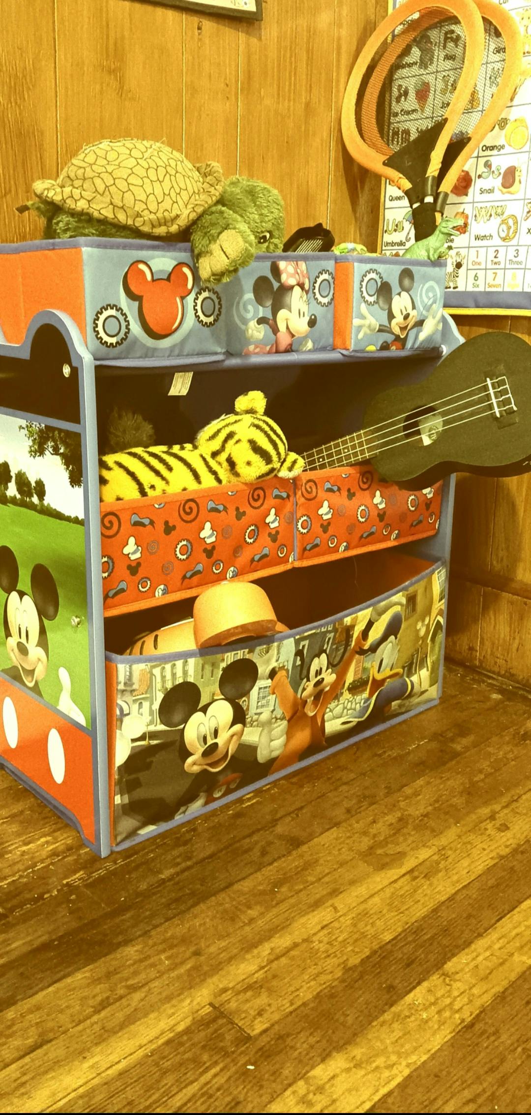 Toy organizer with stuffed animals and a ukulele