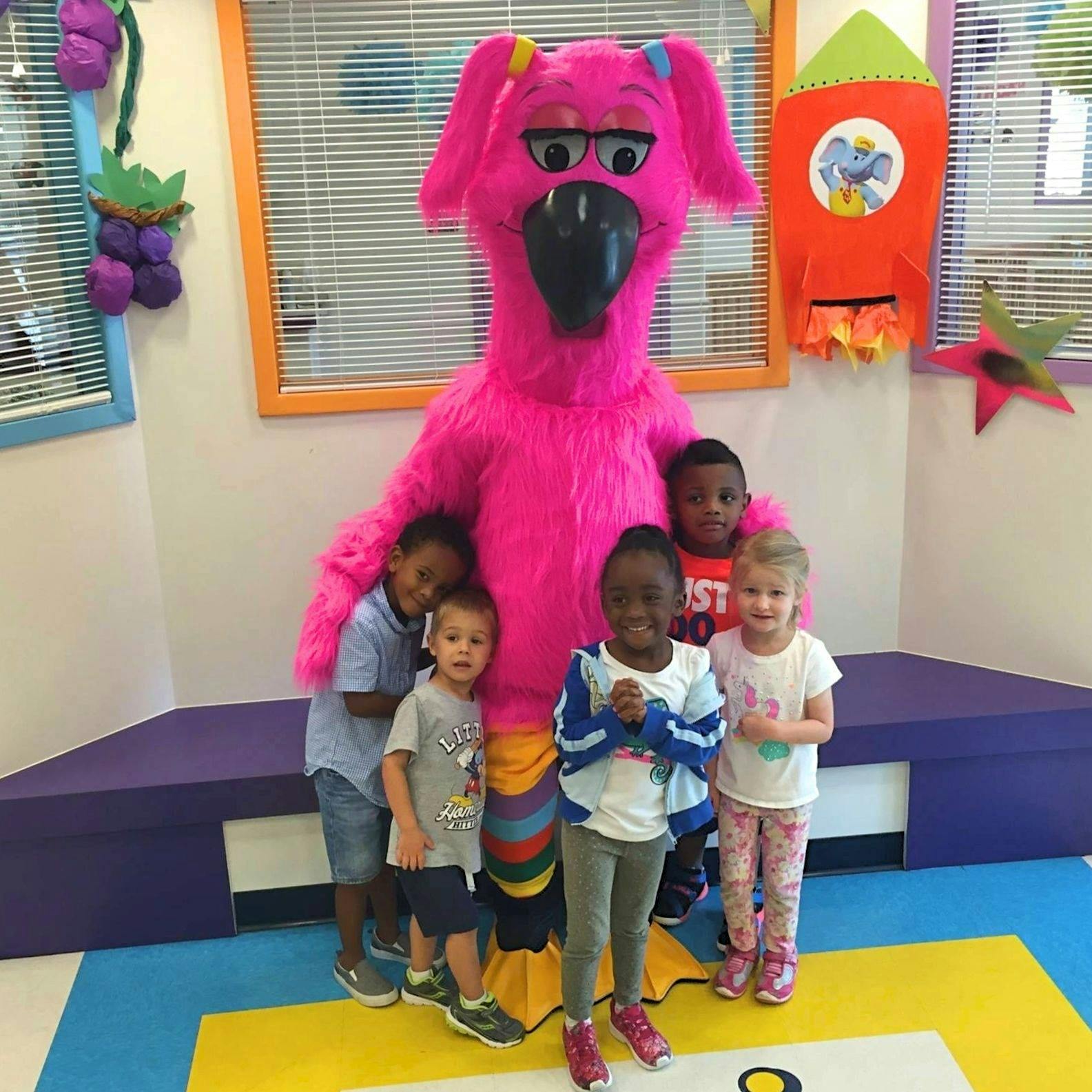 Pink mascot with five children