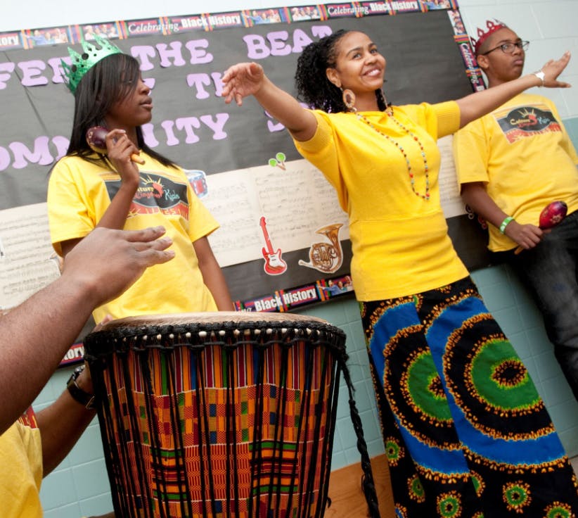 People performing with a drum
