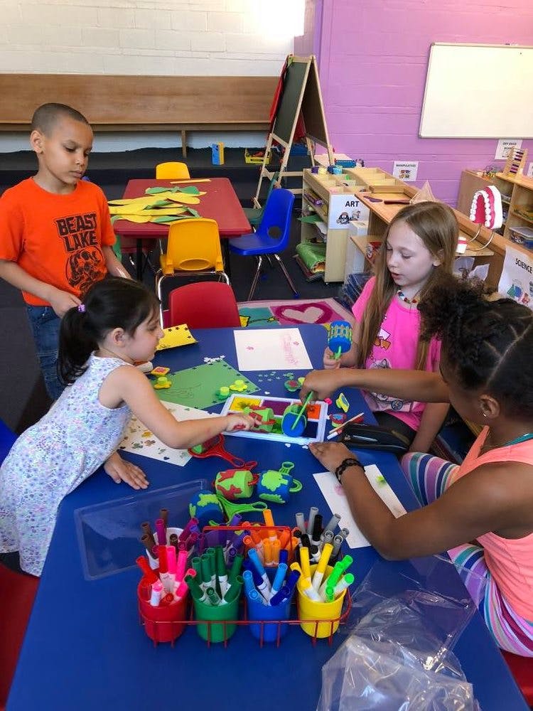 Children at a table doing crafts in-class activities