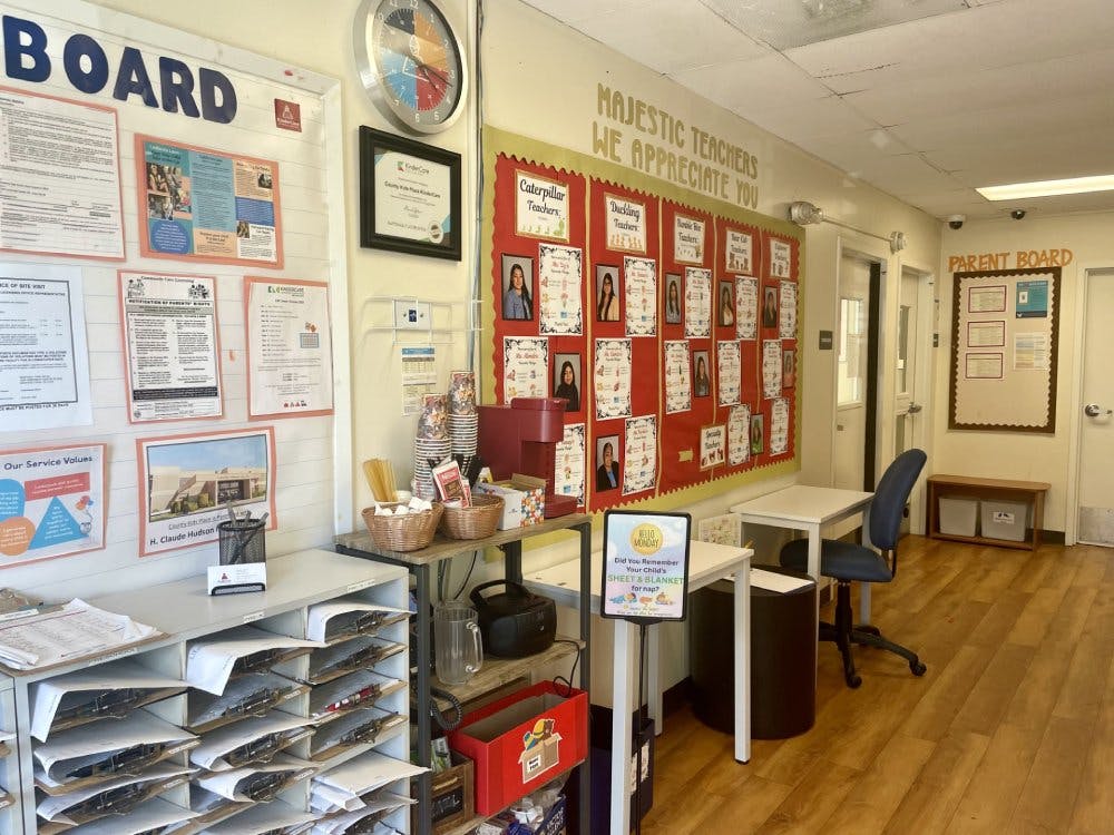 school hallway with bulletin boards, a coffee station, and a sign that says, "MAJESTIC TEACHERS WE APPRECIATE YOU"