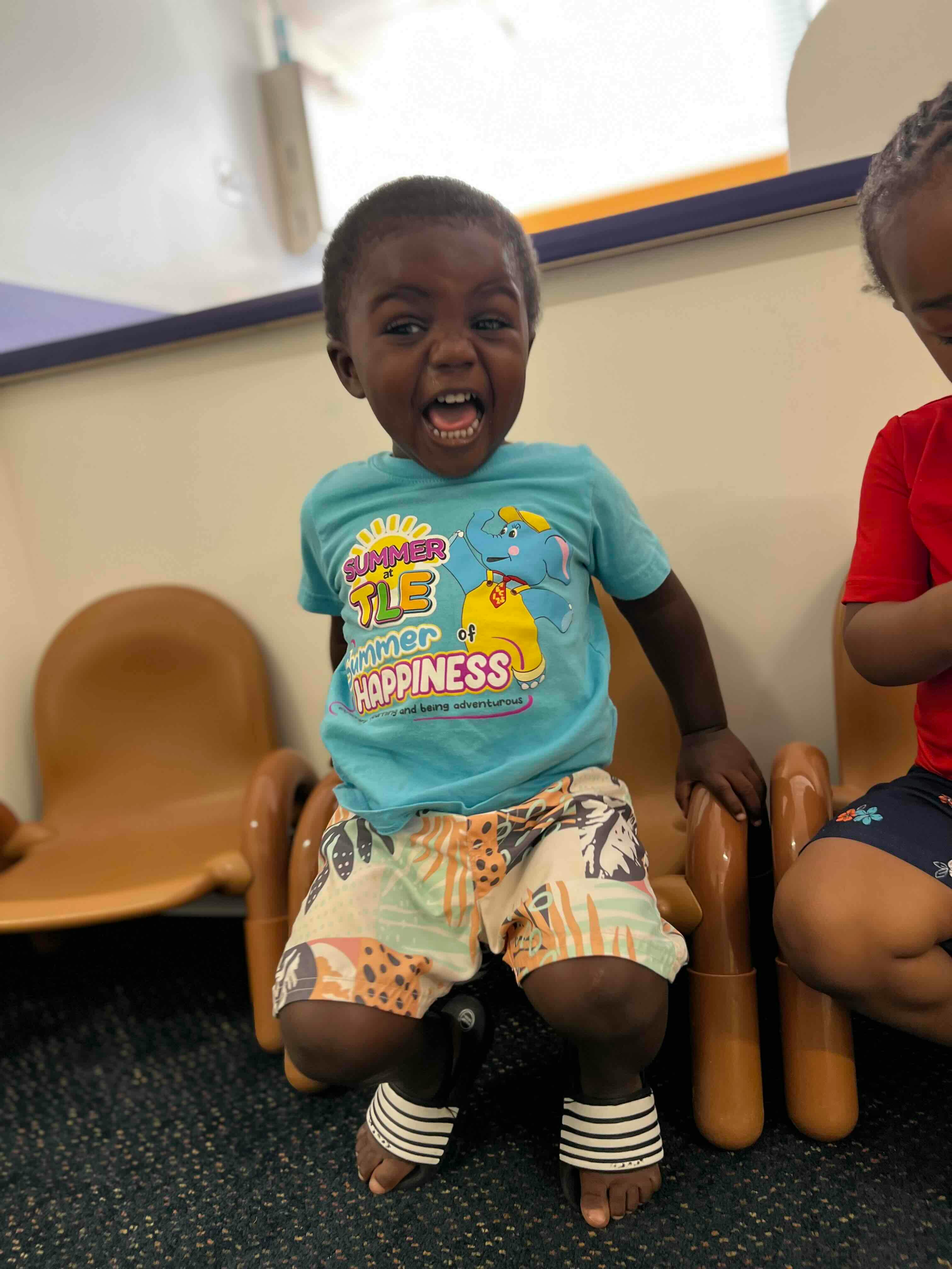 Child sitting on a small chair