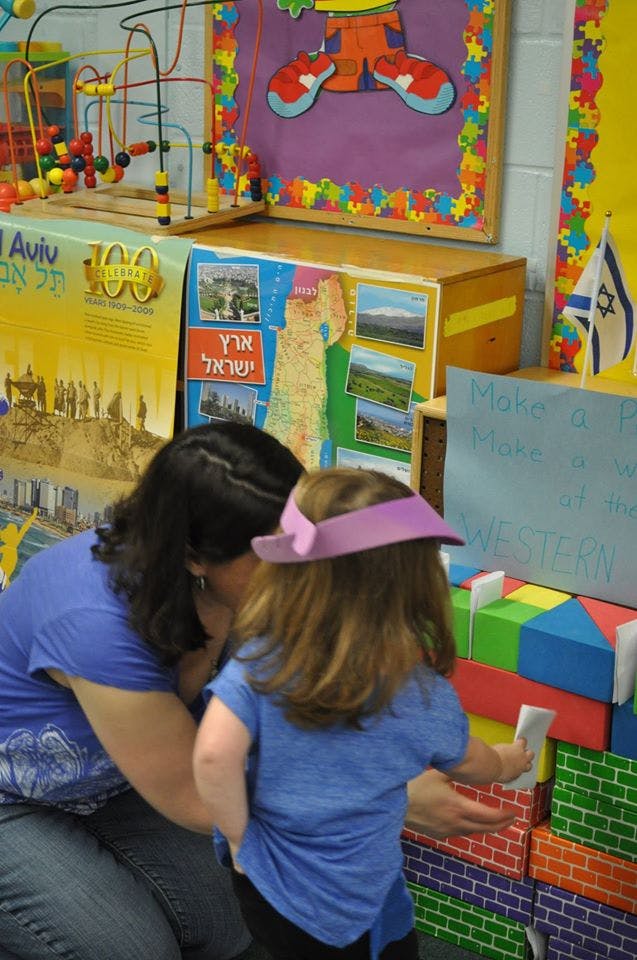 Adult and child playing with colorful blocks
