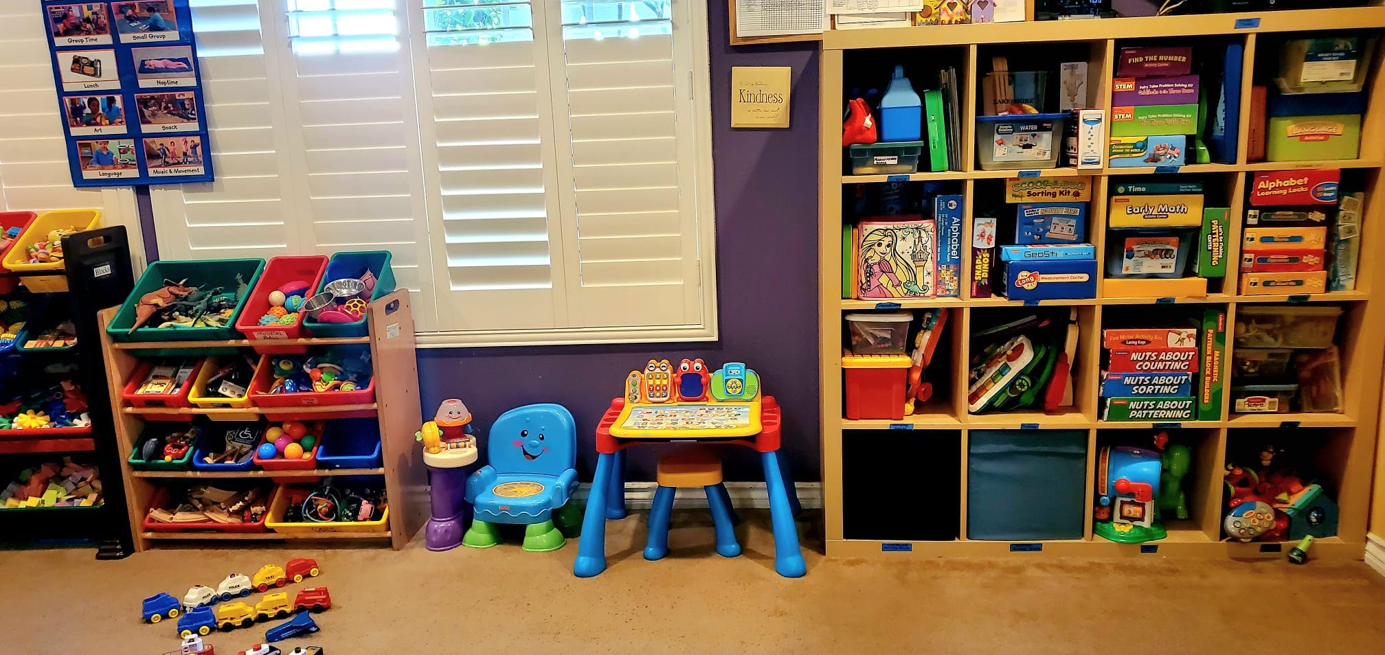 Children's play area with toy storage shelves and small table and chair
