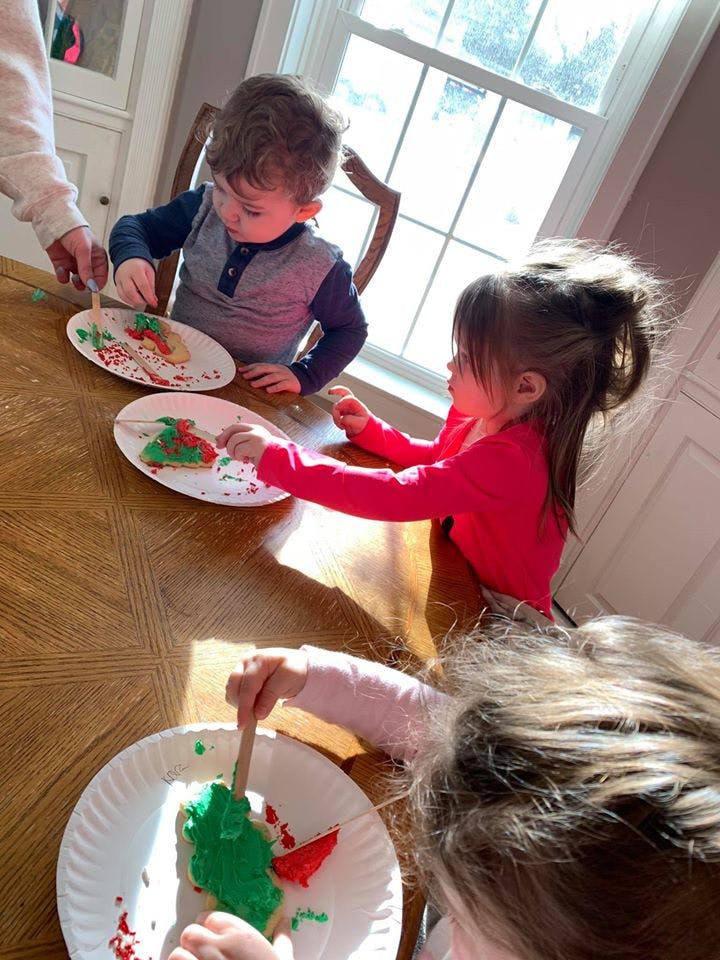 Children decorating cookies at a table