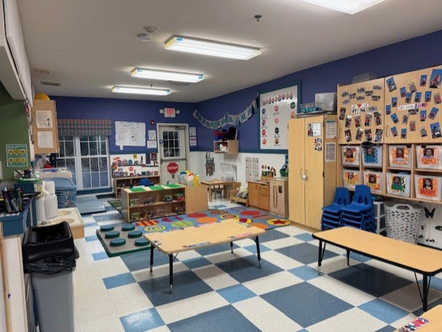 Empty classroom with small tables and chairs