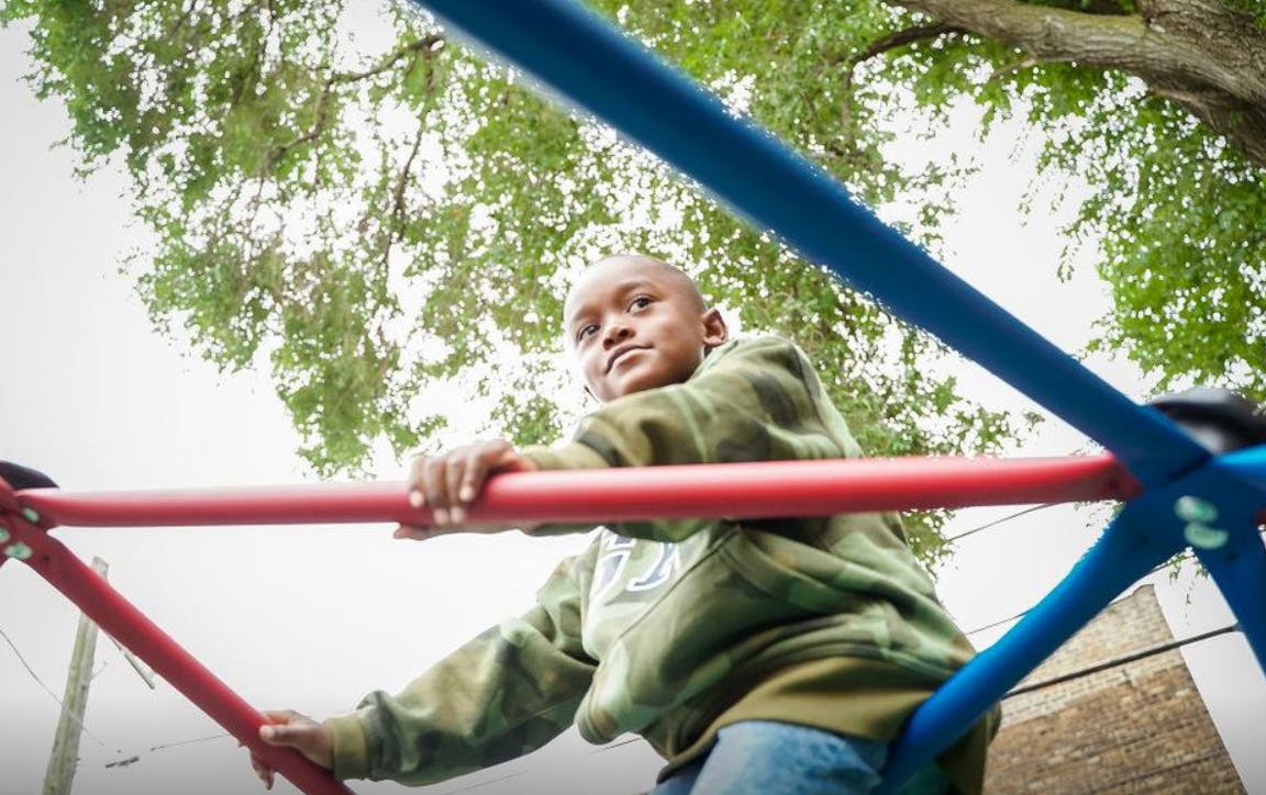 Child on playground climbing structure