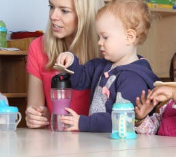 Adult and child at a table with bottles