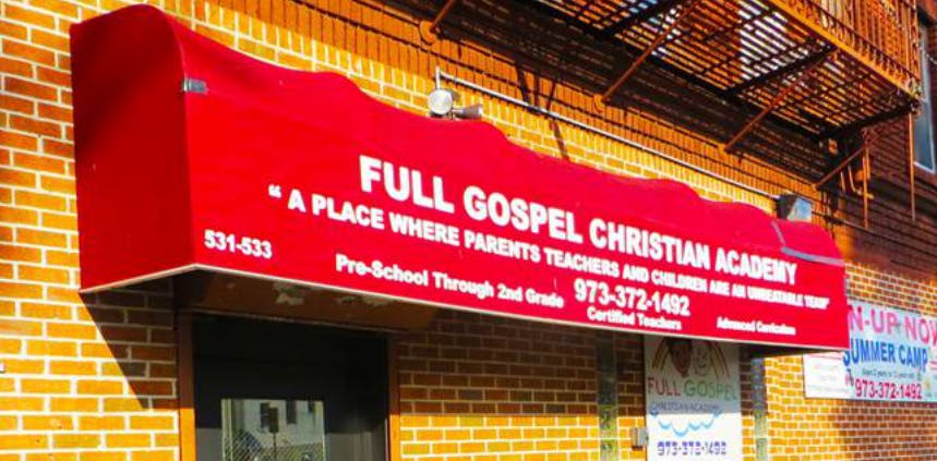 Red awning with "Full Gospel Christian Academy" text