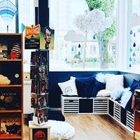 Children's room with a bookshelf, display rack, and seating area