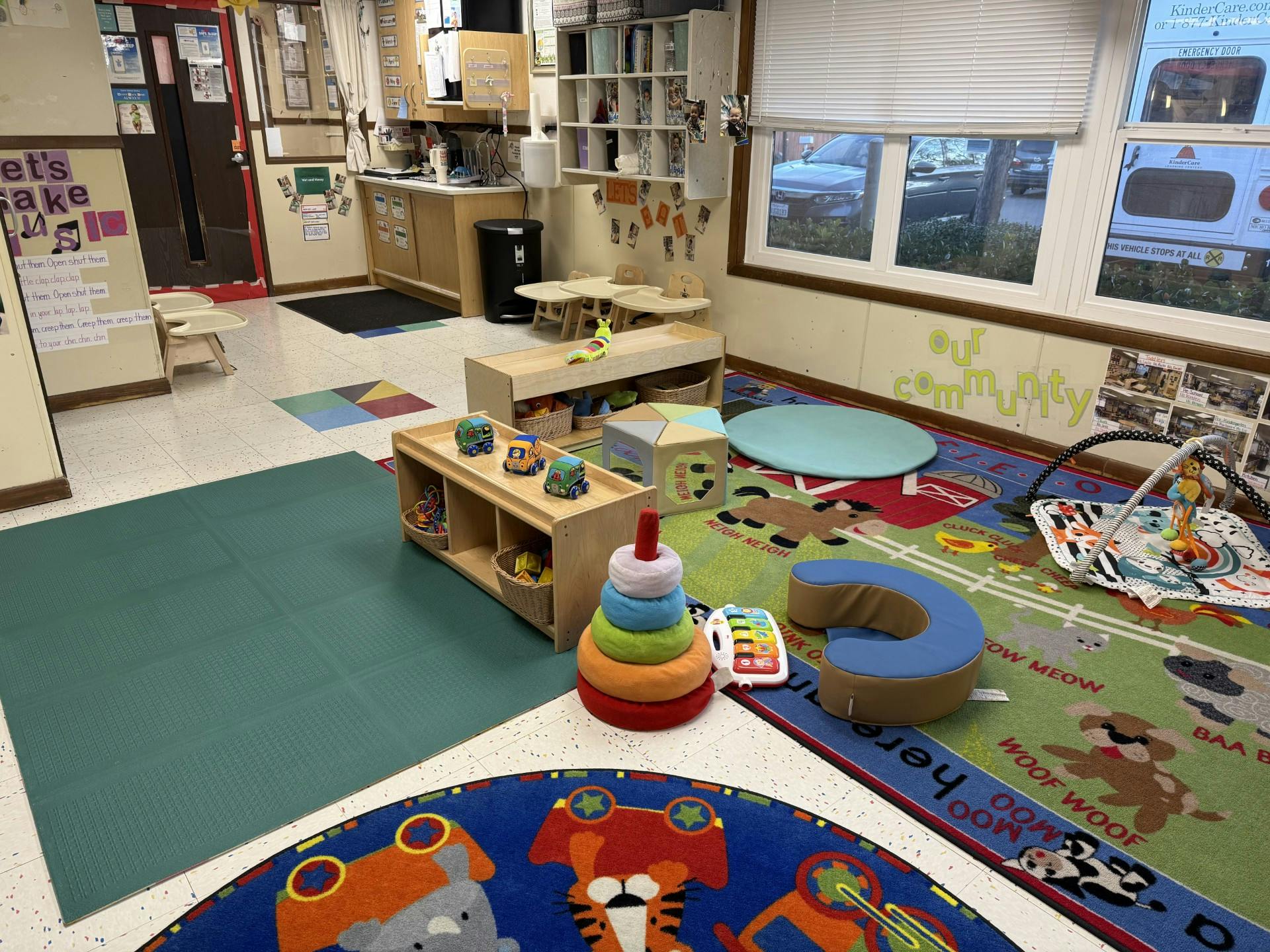 Children's play area with toys, activity mats, and small tables