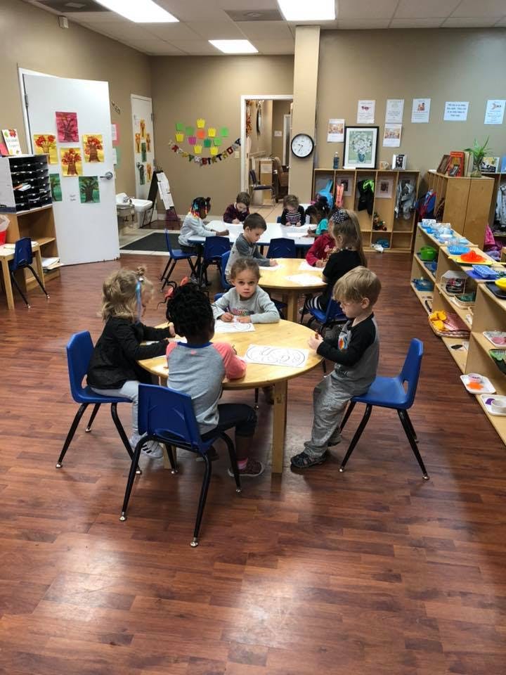 Children sitting at tables in a classroom