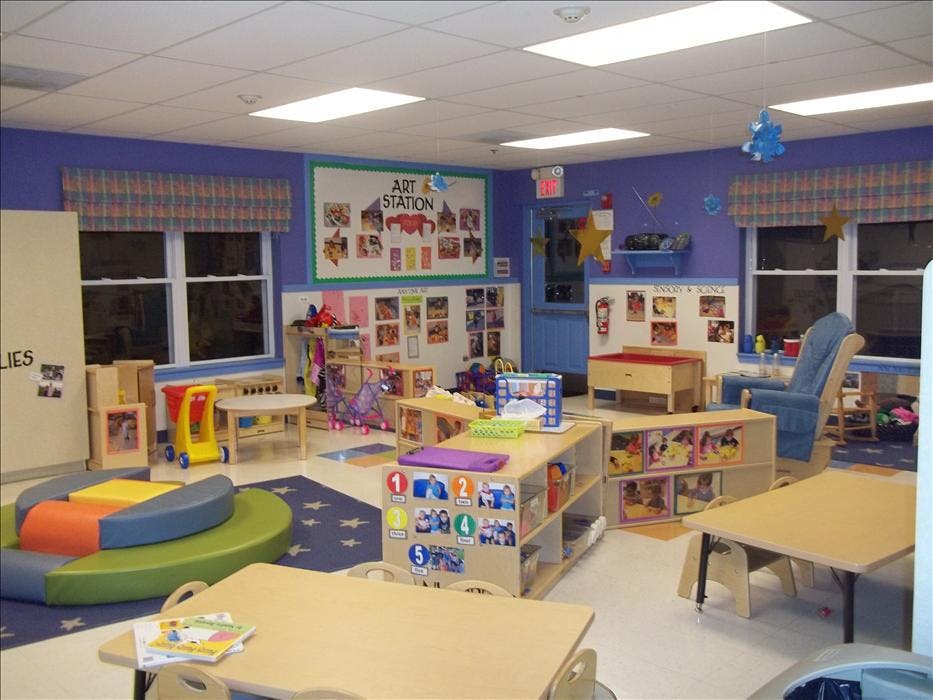 Colorful classroom with various activity stations and child-sized furniture