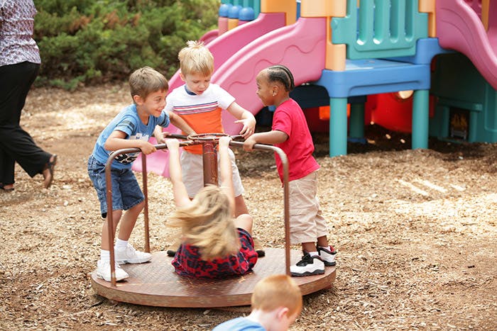 Children playing on a merry-go-round