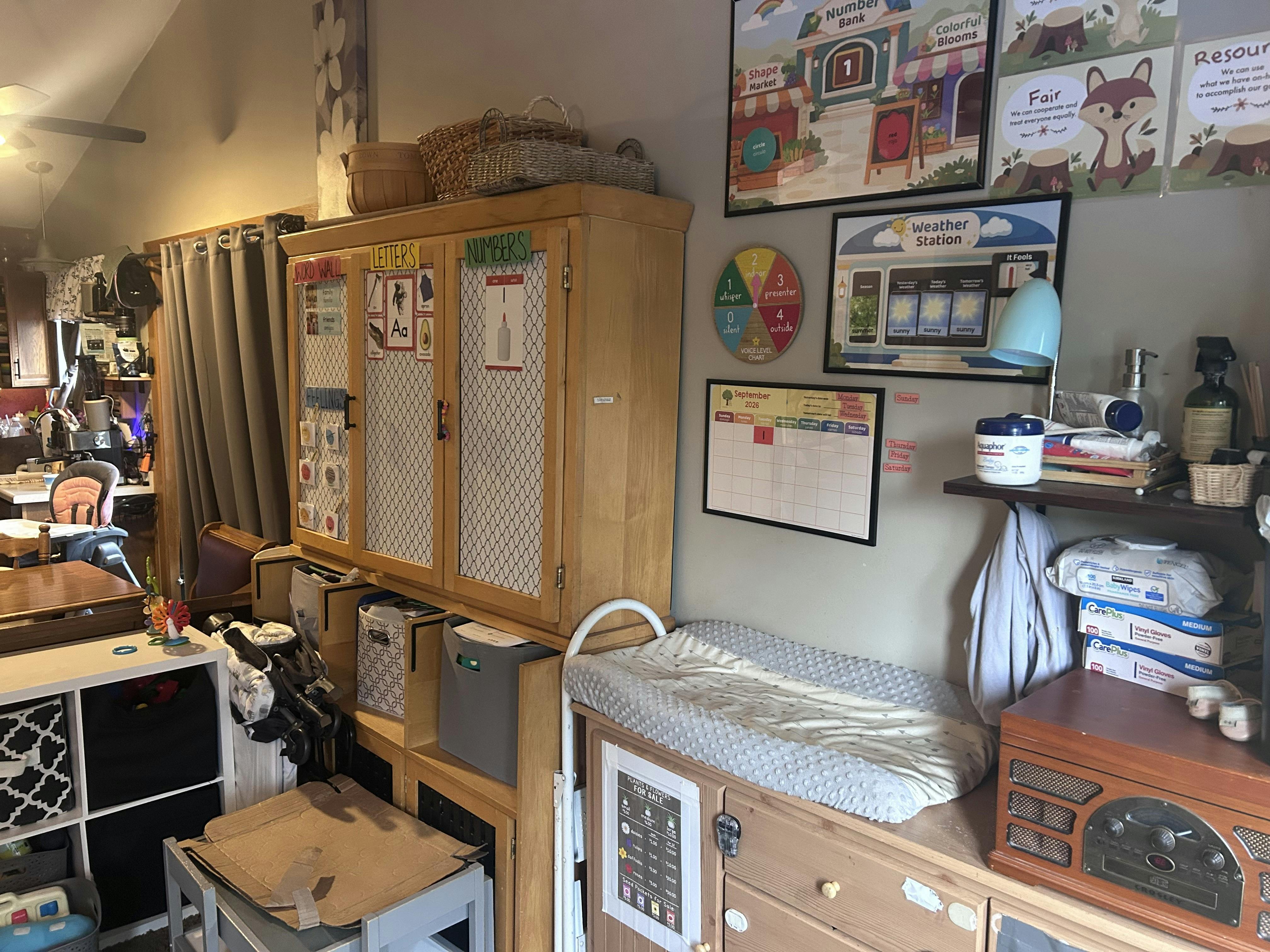 Classroom learning area with storage cabinets and wall-mounted educational charts