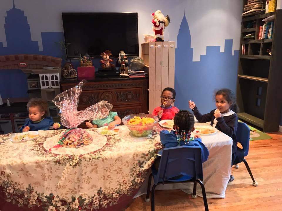 Children sitting at a table with food