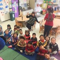 Adults and children in a classroom