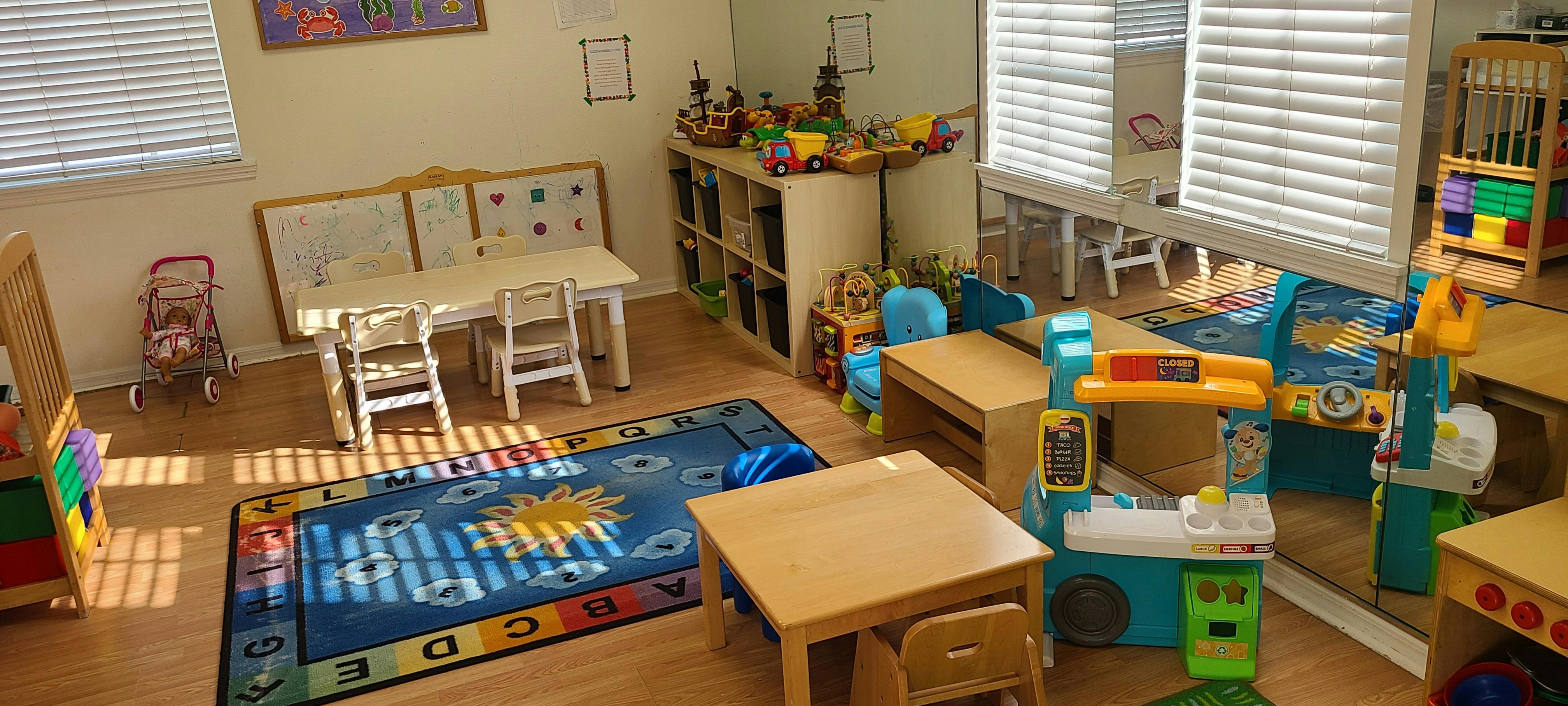 Playroom with small tables, chairs, and toys