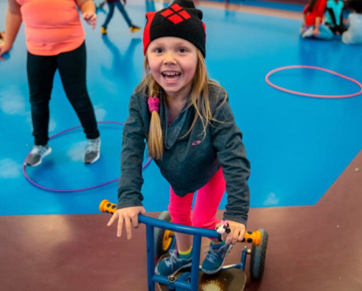 Child on a small riding toy indoors
