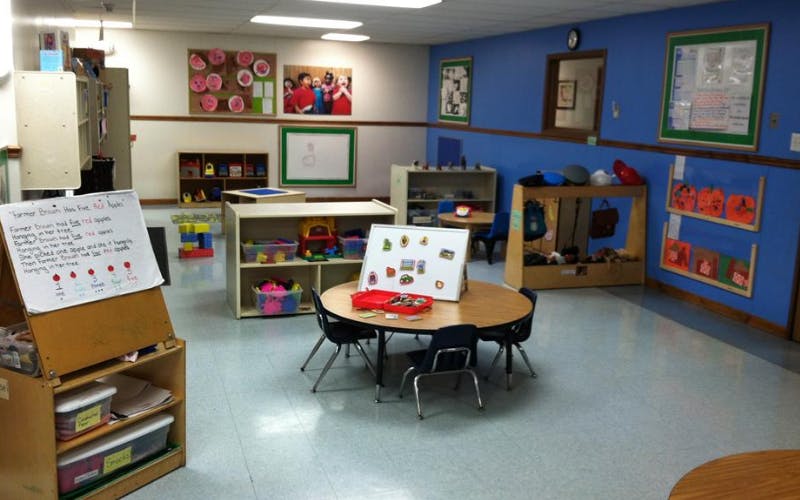 A colorful classroom with small tables, chairs, and learning materials