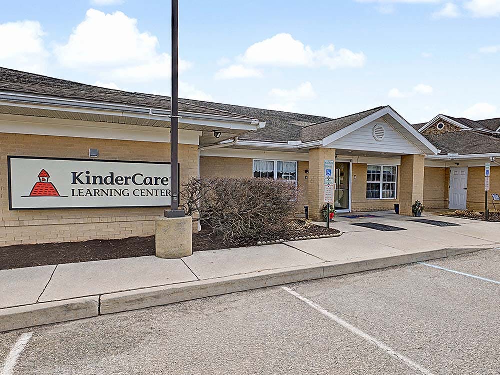 KinderCare Learning Center sign on a brick building with an entrance