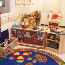 Playroom with toys and a colorful rug