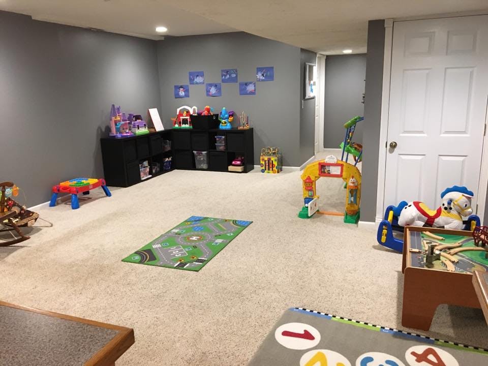 Playroom with toys and play mats on carpet