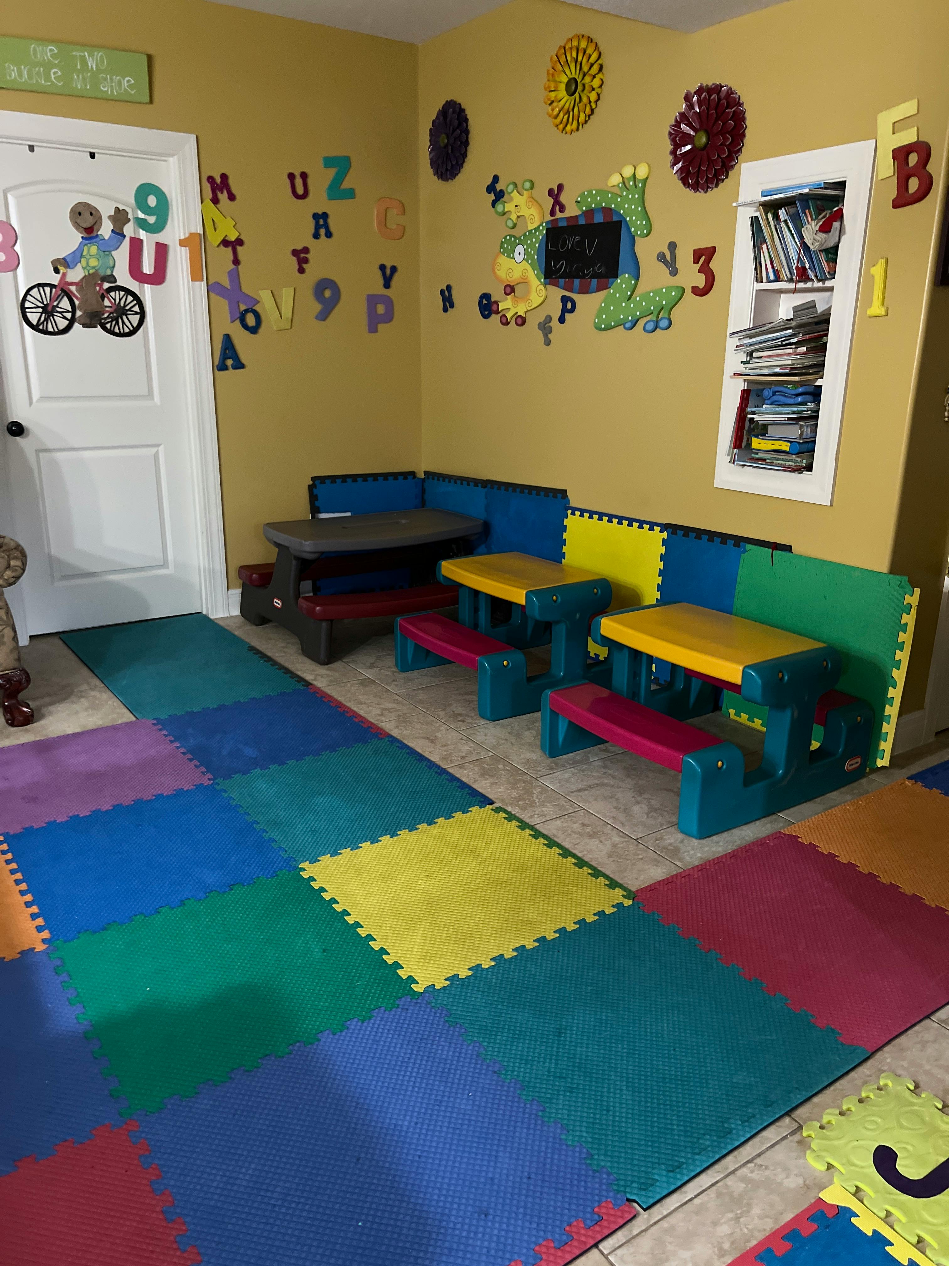 Playroom with colorful floor mats and small tables
