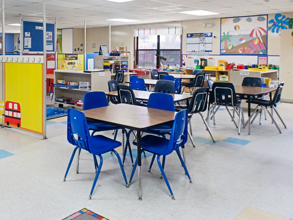 Empty classroom with small tables and chairs