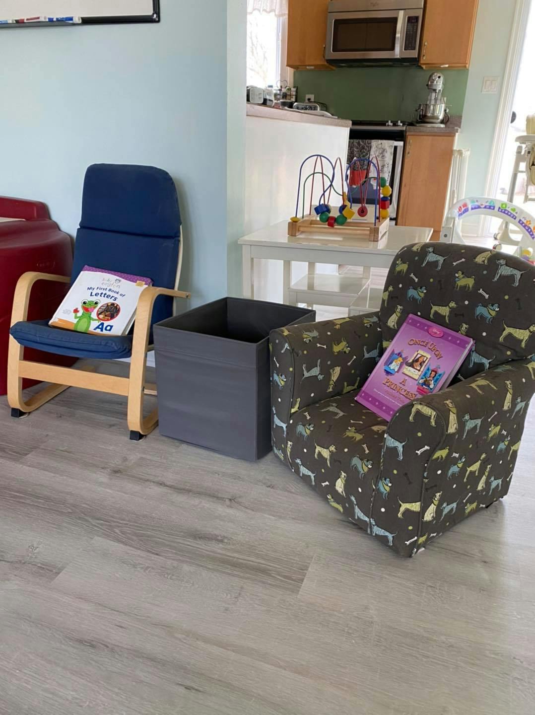Two chairs with books on them next to a storage bin
