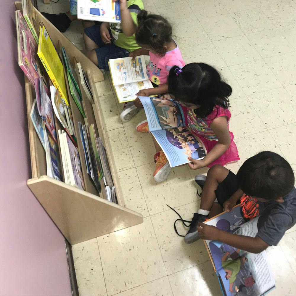 Children sitting on the floor reading books