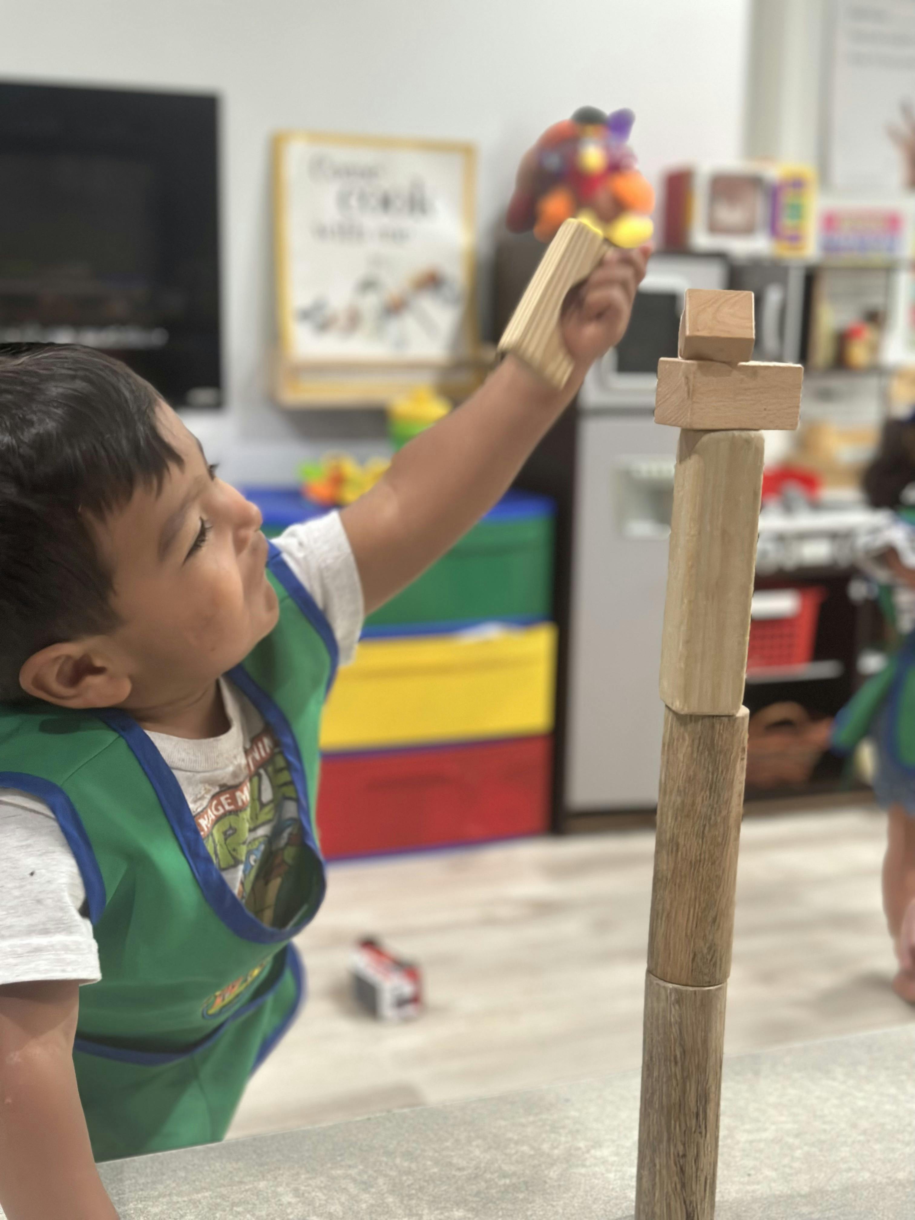 Child stacking wooden blocks