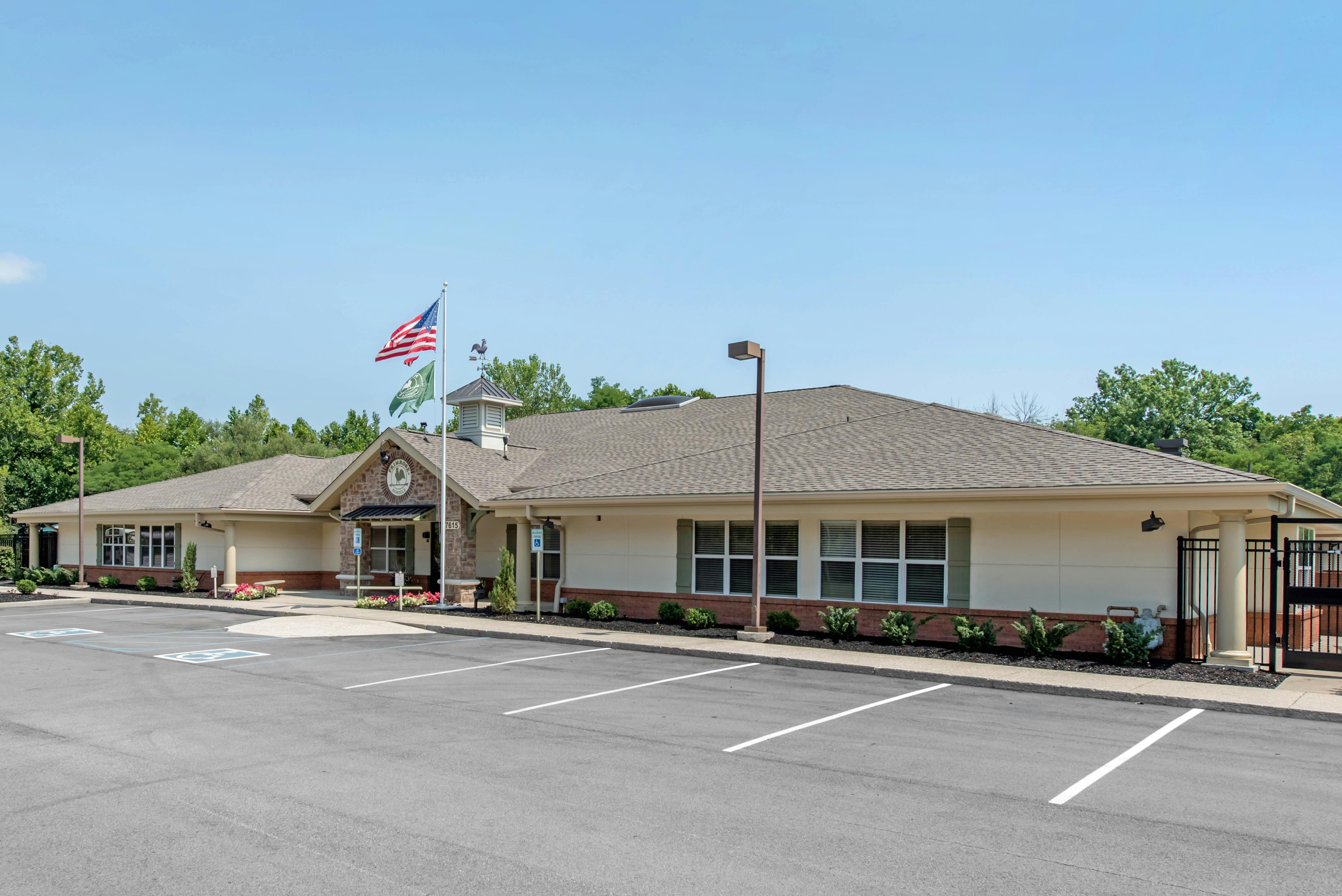 Exterior view of a single-story building with a parking lot in front