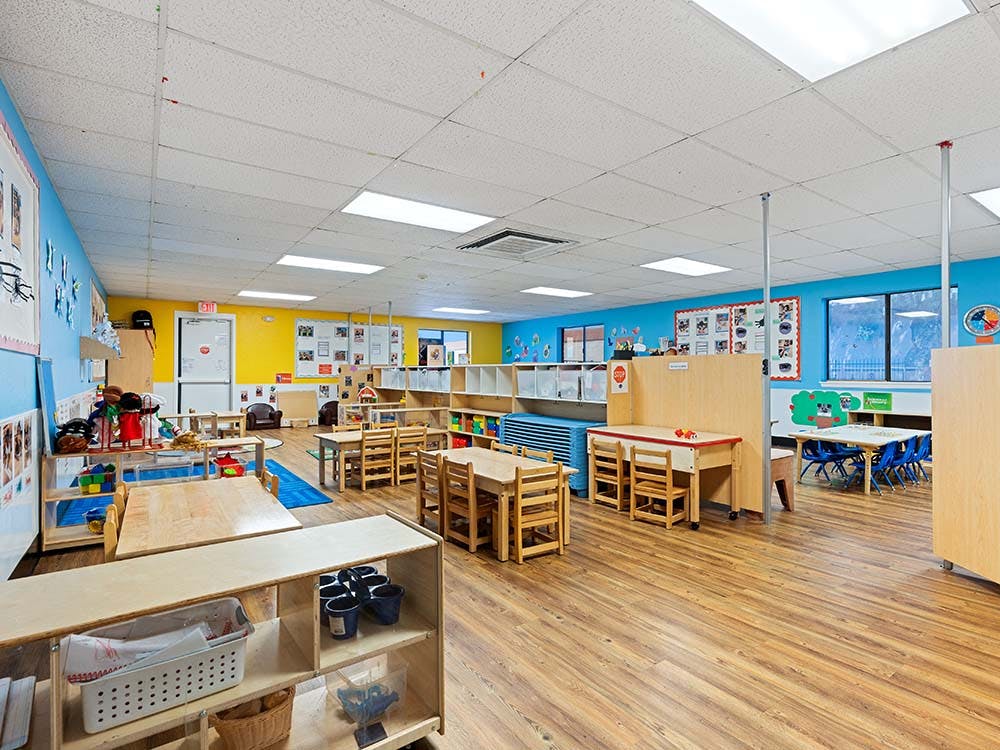 Empty classroom with small tables and chairs