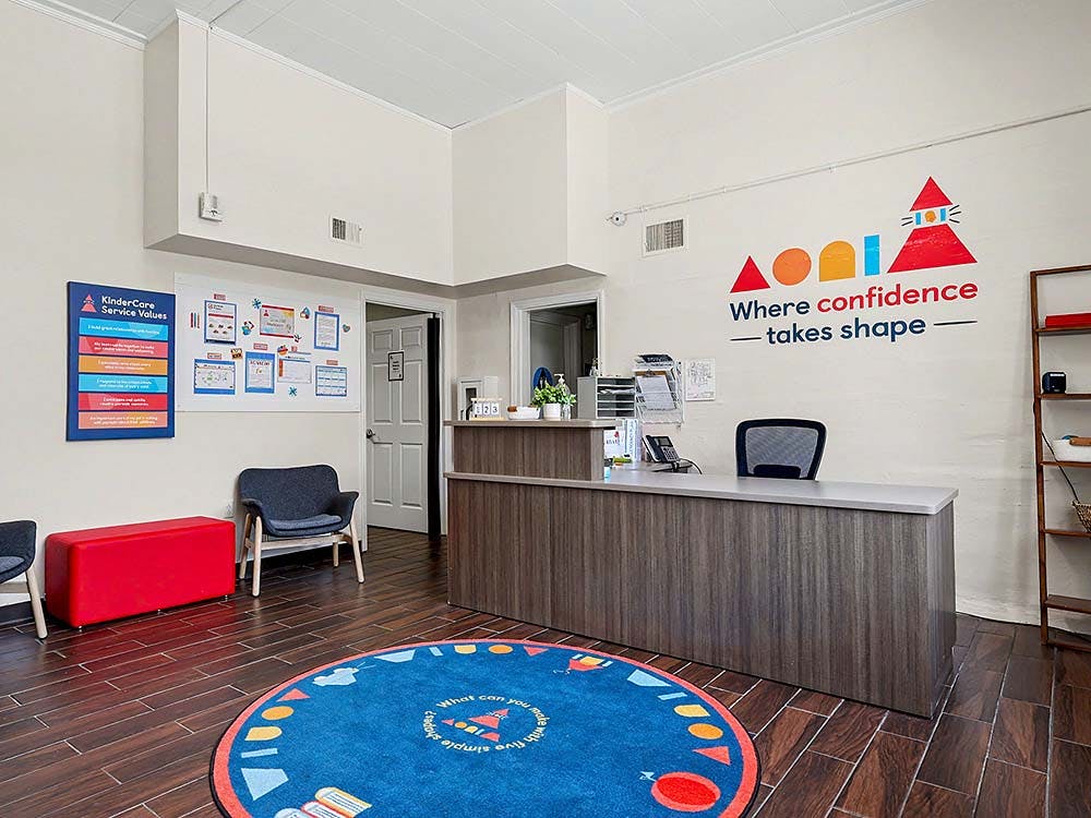 Reception desk with a colorful mural on the wall in an office